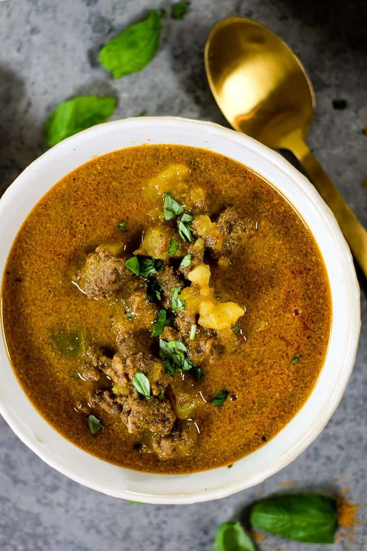 This Paleo and Whole30 curry beef stew is real good, and we've provided you instructions to make it in either the Instant Pot or slow cooker! It's packed with comfort foods like potatoes, savory curry flavors, gut healing bone broth and creamy coconut milk. | realsimplegood.com #paleo #whole30 #instantpot #slowcooker