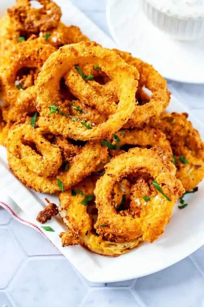 Onion rings on a plate with chopped parsley