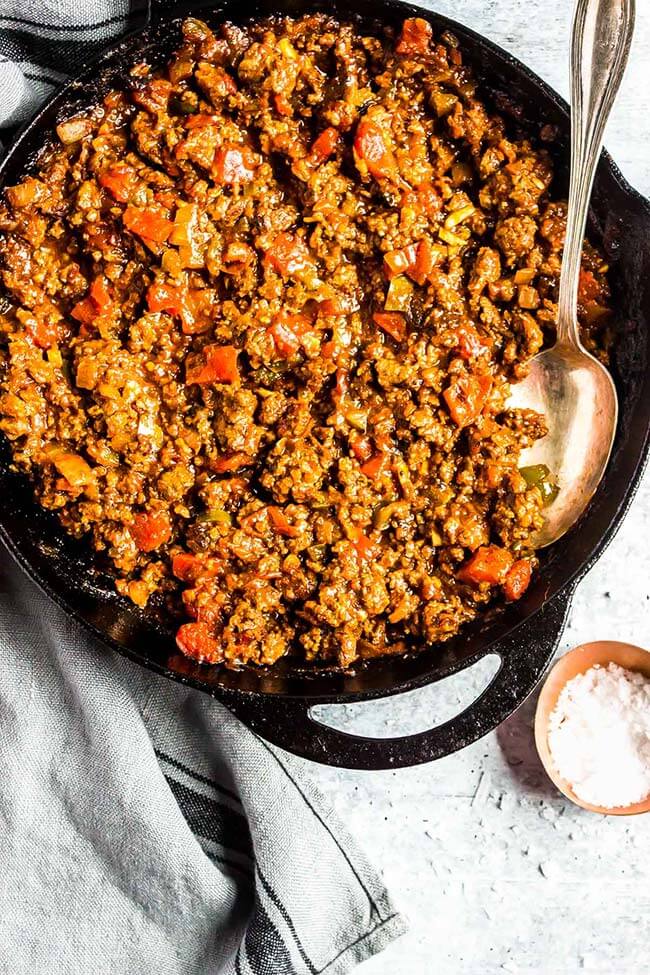 Keto sloppy joes in a cast iron skillet with silver spoon sticking out