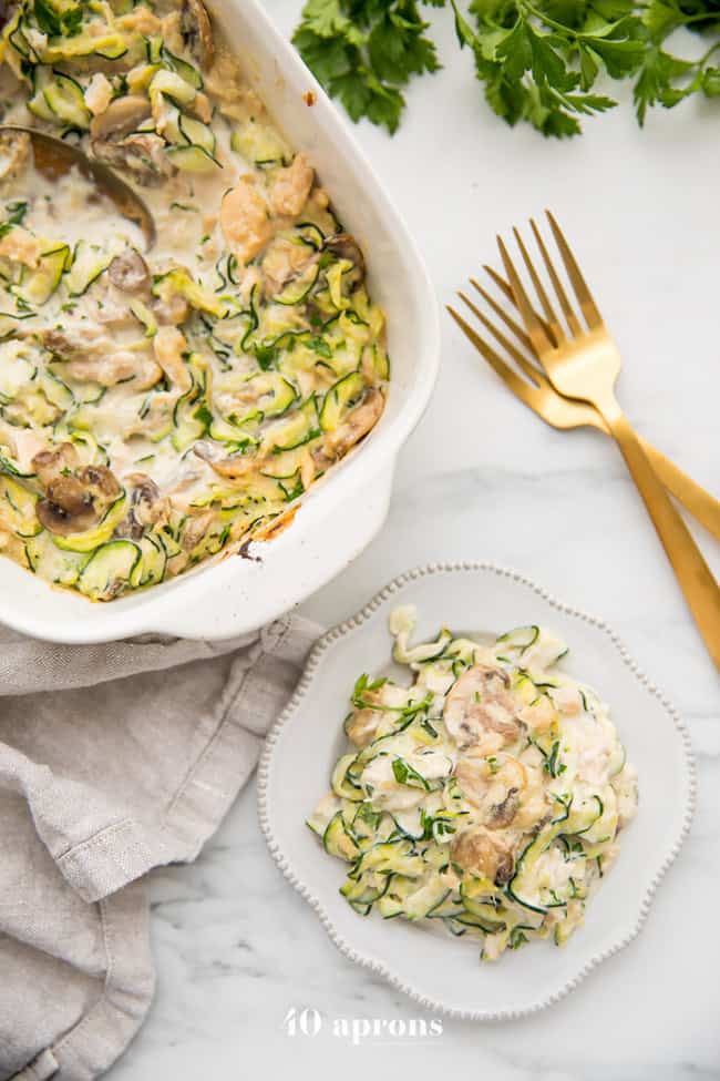 Whole30 tuna zoodles casserole with casserole dish and serving on plate with forks - healthy casseroles