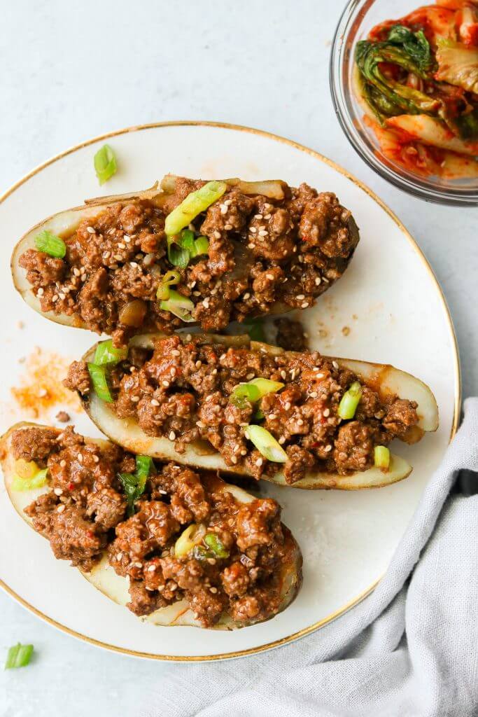 Sloppy joes stuffed in potatoes that are cut in half and topped with sliced green onion