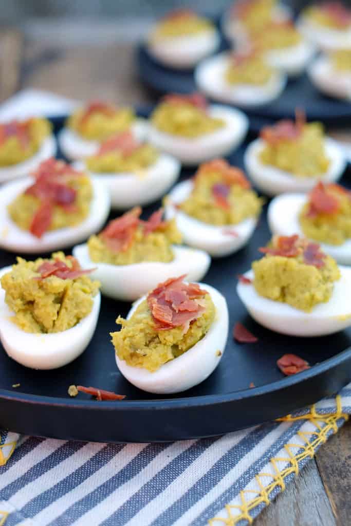 These mayo free deviled eggs have a mix of creamy avocado combined with crispy and salty prosciutto. Easy to make and the perfect Paleo appetizer! Paleo and Gluten-Free. | realsimplegood.com