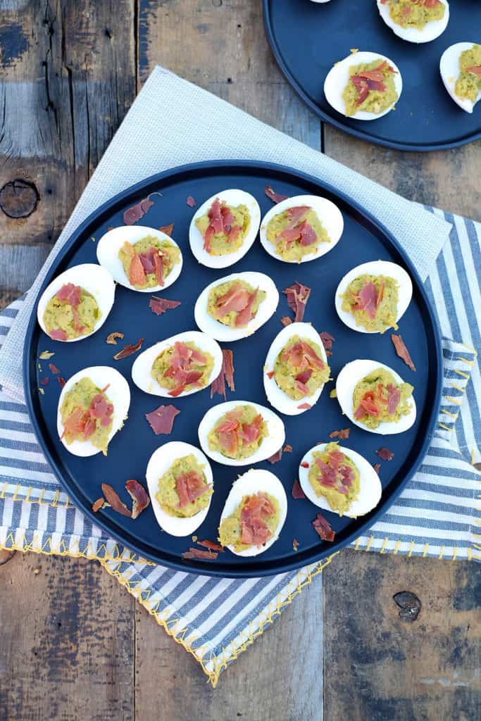 These mayo free deviled eggs have a mix of creamy avocado combined with crispy and salty prosciutto. Easy to make and the perfect Paleo appetizer! Paleo and Gluten-Free. | realsimplegood.com