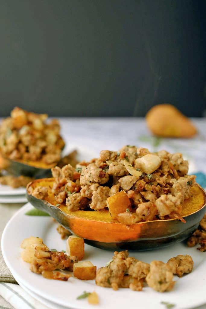 This Paleo + Whole30 pork and pear stuffed acorn squash has apples and squash paired with sausage, sage and onion for an easy, healthy meal. Paleo + Whole30. | realsimplegood.com