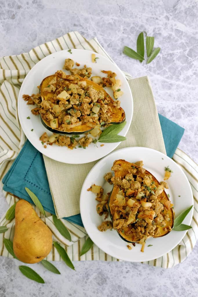 This Paleo + Whole30 pork and pear stuffed acorn squash has apples and squash paired with sausage, sage and onion for an easy, healthy meal. Paleo + Whole30. | realsimplegood.com