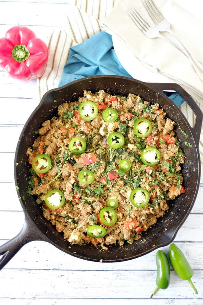 This Paleo + Whole30 version of dirty cauliflower rice is spicy, rich, filling and incredibly tasty. It's not a side dish, it's a whole meal! Italian sausage, jalapeno, bell peppers kale and mushrooms. Paleo + Whole30. | realsimplegood.com