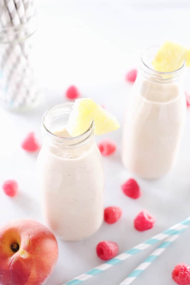 This peach berry pina colada smoothie is packed with peach, pineapple, raspberries and banana. It's clean, easy to make, and makes it feel like you're on vacation! Paleo and Refined Sugar-Free. | realsimplegood.com