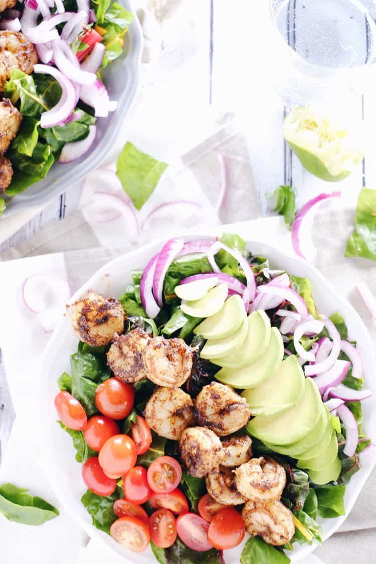 This cajun shrimp salad is an easy and fresh salad option. Make the Paleo + Whole30 salad packed with shrimp, avocado, tomato and onion! Paleo, Whole30, Gluten-Free + Dairy-Free. | realsimplegood.com