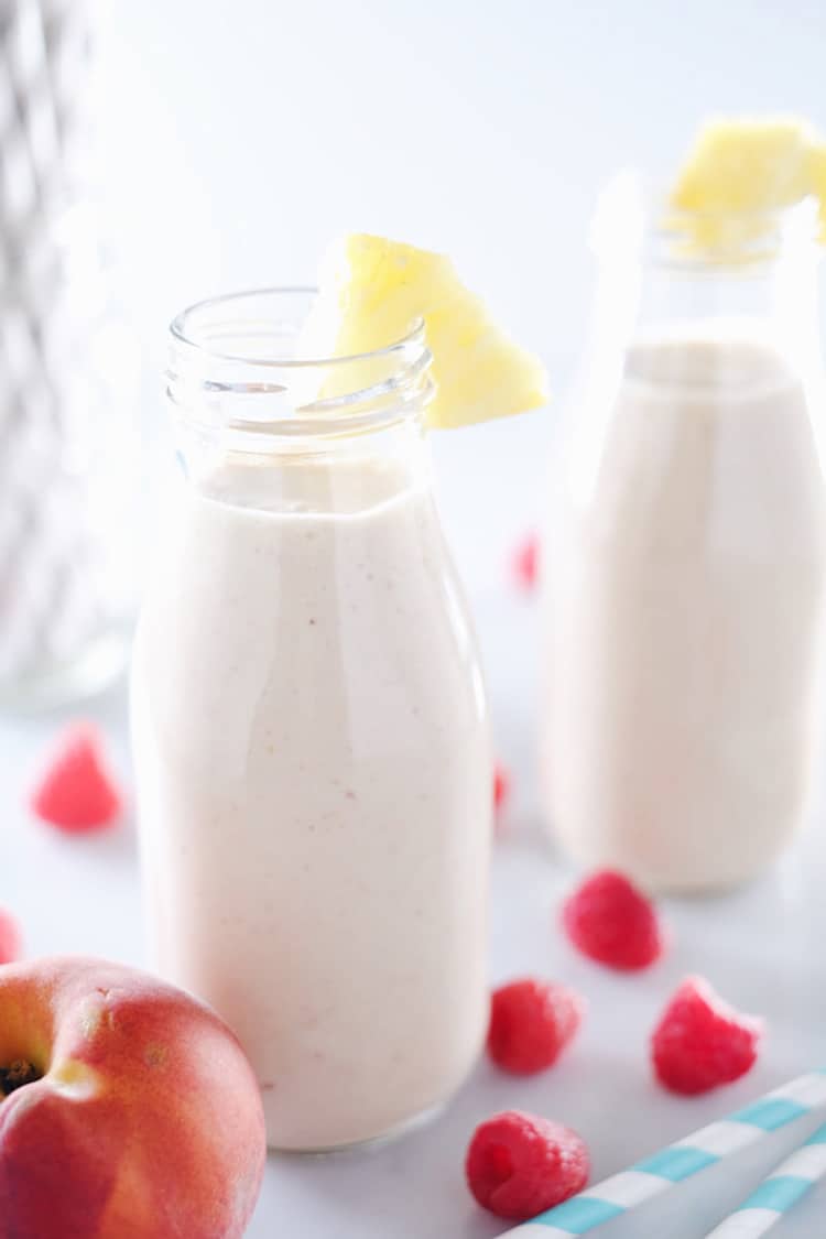 This peach berry pina colada smoothie is packed with peach, pineapple, raspberries and banana. It's clean, easy to make, and makes it feel like you're on vacation! Paleo and Refined Sugar-Free. | realsimplegood.com