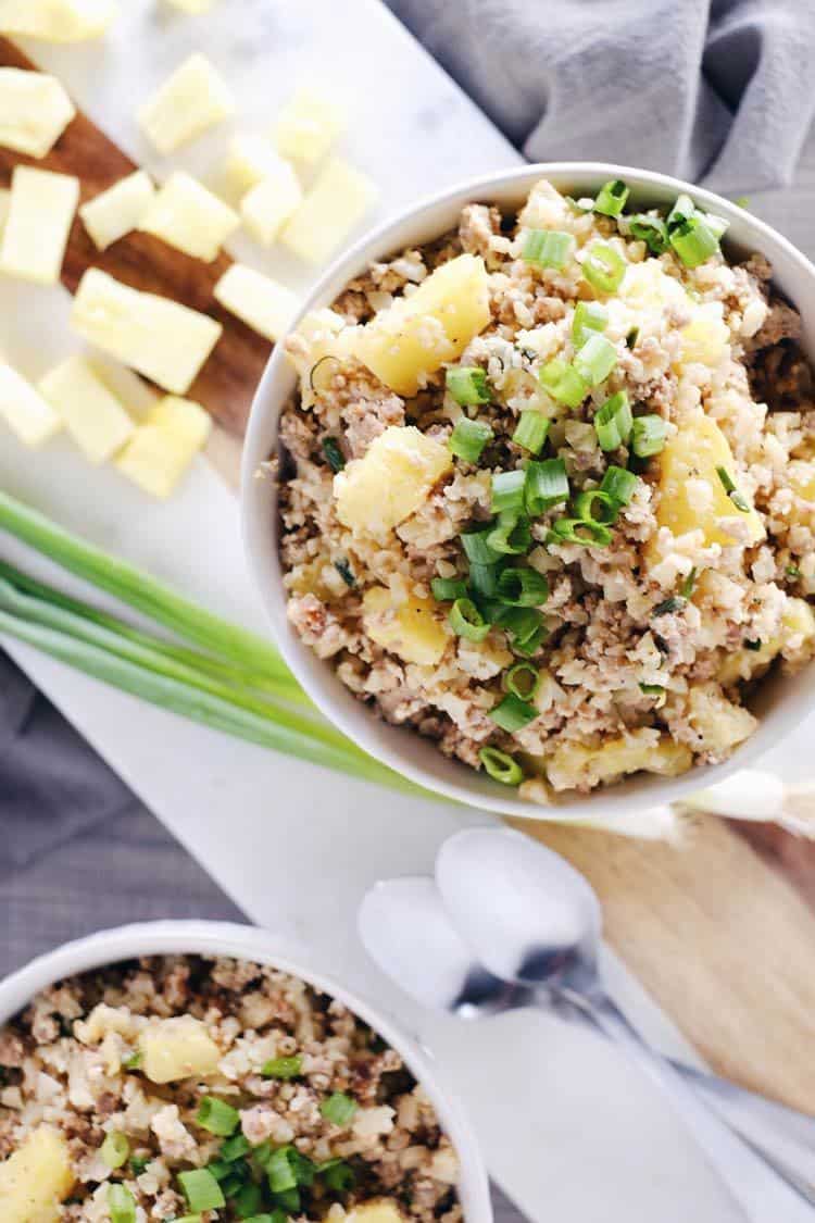 We love this spicy pineapple cauliflower pork fried rice recipe because there are less than 10 ingredients. Paleo + Whole30, it's quick + easy to make! Paleo, Whole30, Gluten-Free + Dairy-Free. | realsimplegood.com