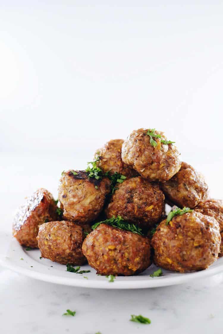 Stack of butternut breakfast meatballs on a white plate