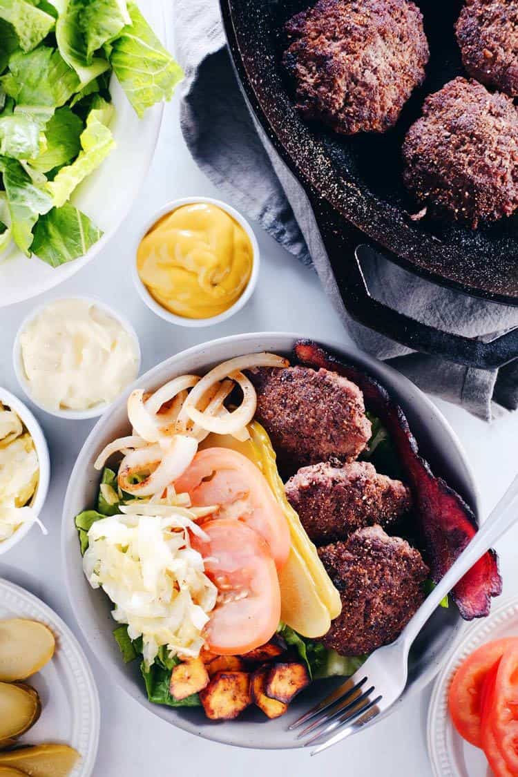 These Paleo + Whole30 mini burger bowls are simple, easy to throw together and full of what you need and want - healthy fats, protein, veggies and greens! Paleo, Whole30, Gluten-Free + Dairy-Free. | realsimplegood.com