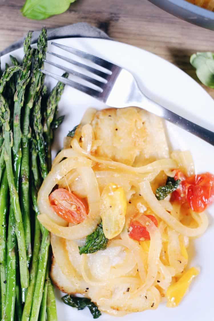 This tomato basil cod with asparagus is a quick and easy favorite! It feels fancy, but is really a simple and quick Paleo + Whole30 meal! Paleo, Whole30, Gluten-Free + Dairy-Optional. | realsimplegood.com