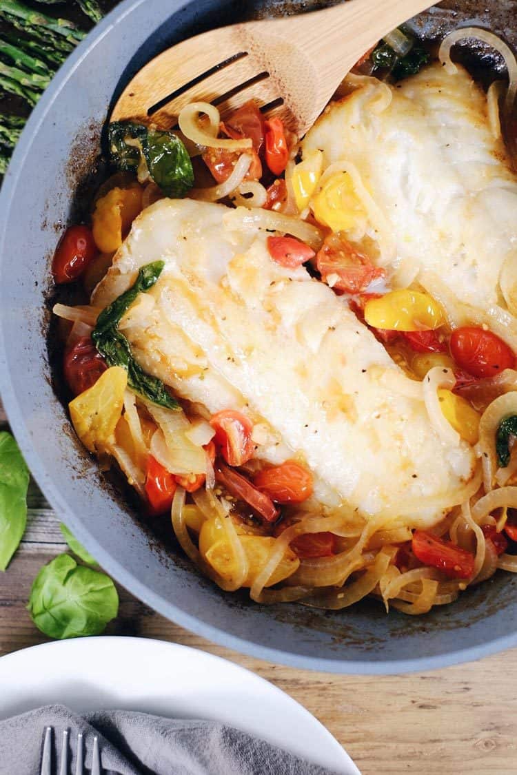 This tomato basil cod with asparagus is a quick and easy favorite! It feels fancy, but is really a simple and quick Paleo + Whole30 meal! Paleo, Whole30, Gluten-Free + Dairy-Optional. | realsimplegood.com