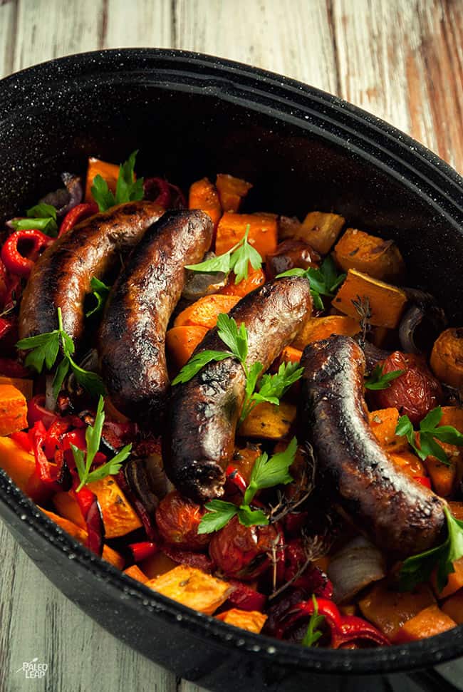Simple sausage casserole in deep black dish, four sausages on top - healthy casseroles
