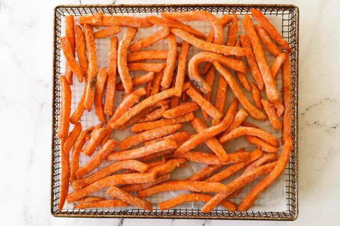 Frozen, seasoned sweet potato fries in air fryer basket