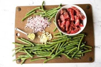 Prep image of sliced beef, green beans, chopped shallot garlic and ginger