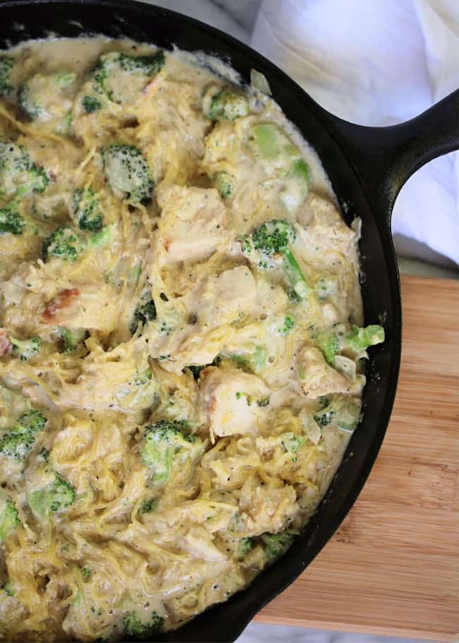 chicken alfredo pasta in skillet with broccoli