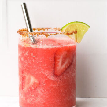 Close in straight on shot of single glass of frozen strawberry daiquiri mocktail