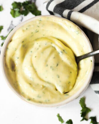 Overhead image of ramekin with cilantro lime aioli and spoon in it.