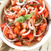 Close up overhead shot of chopped tomato and onion salad