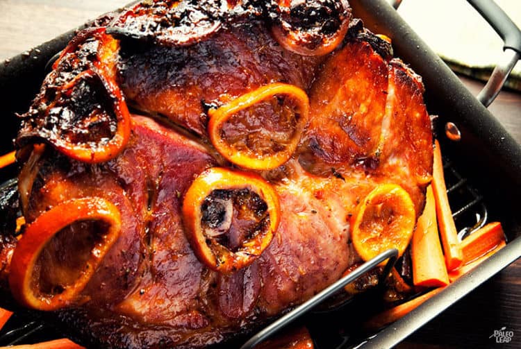 Orange glazed ham in a roasting pan