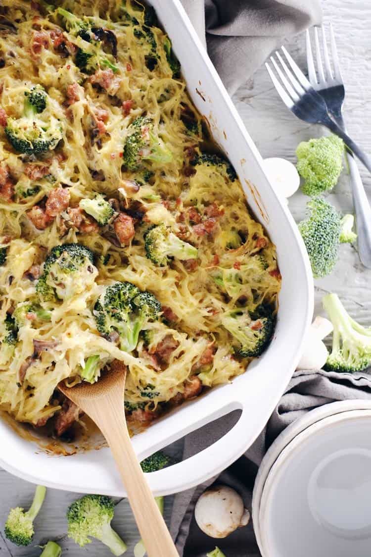 Creamy garlic spaghetti squash casserole in dish with forks and spoon - healthy casseroles