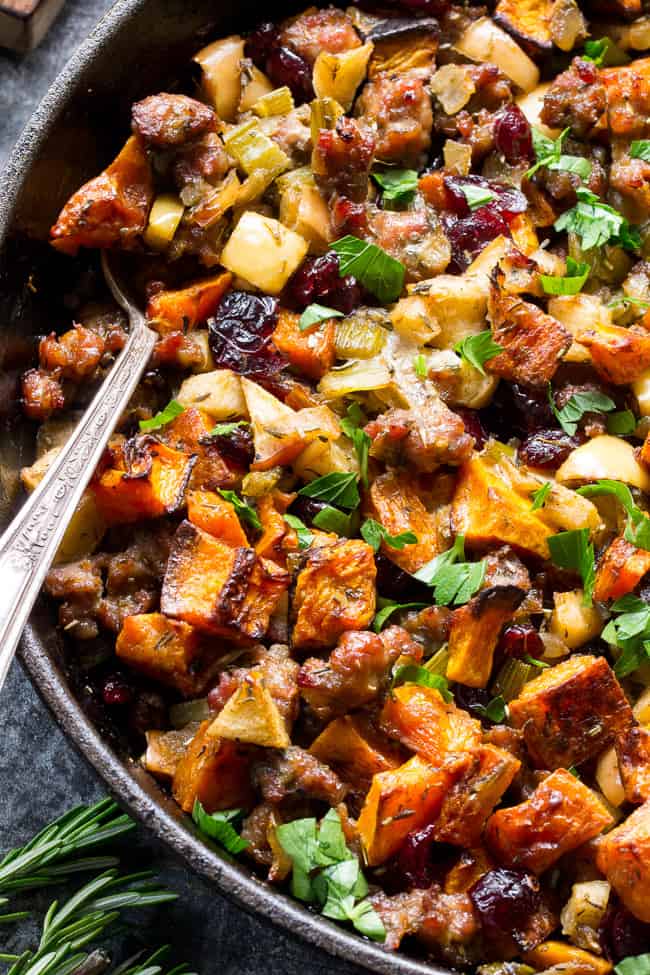 Butternut squash stuffing in a skillet with a spoon