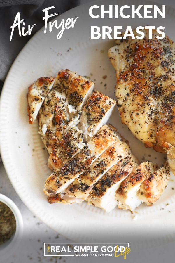 Chicken breasts on a plate with one sliced. Text at top for pinterest.