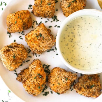 Gluten free air fryer chicken nuggets on a plate with ranch dipping sauce.