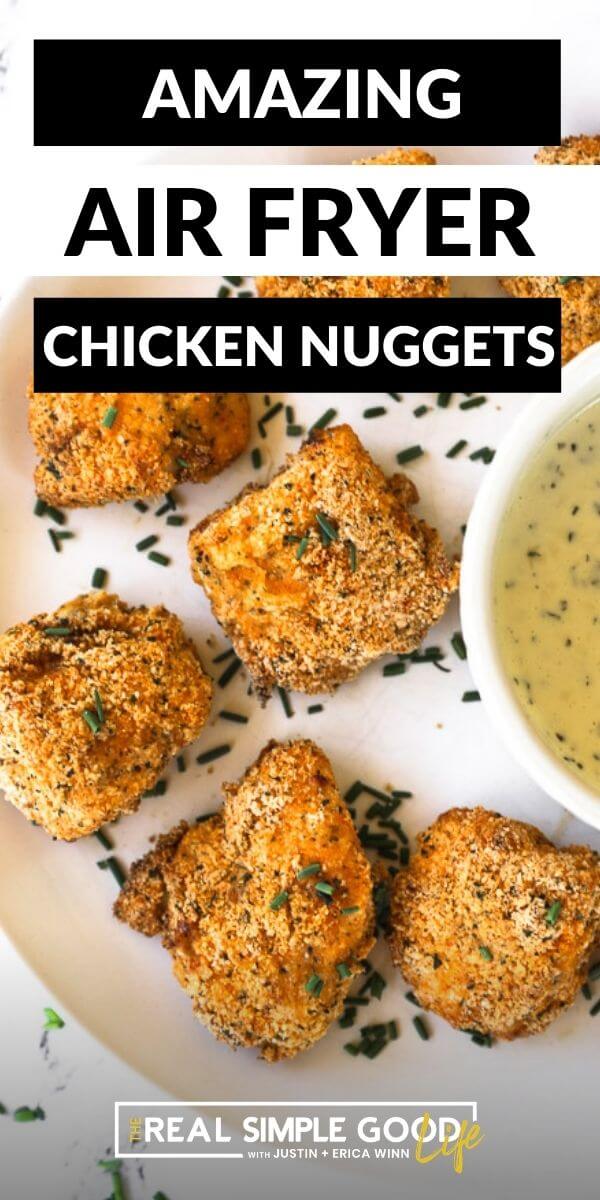 Vertical image of air fryer nuggets on a plate with text overlay at the top. 