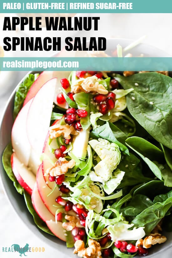 Close up vertical image of apple walnut spinach salad in a bowl with text overlay at top. 