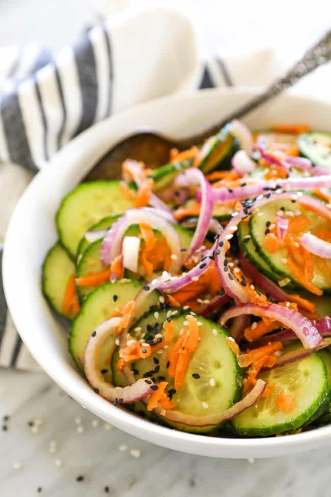 Asian cucumber salad in bowl at an angle