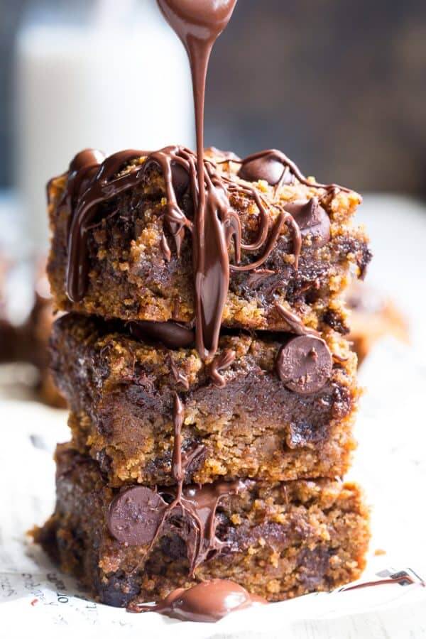 Stack of three fudgy bars with chocolate flowing over top and side