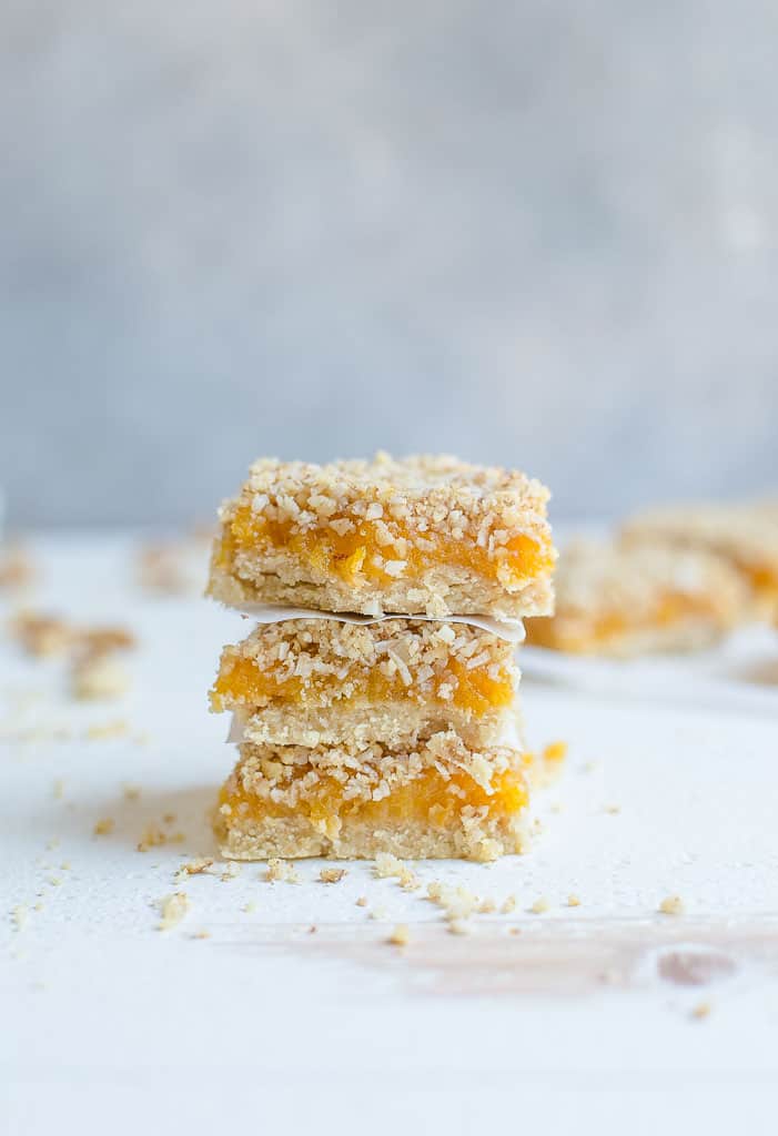 Stack of three apricot bars with crumble topping