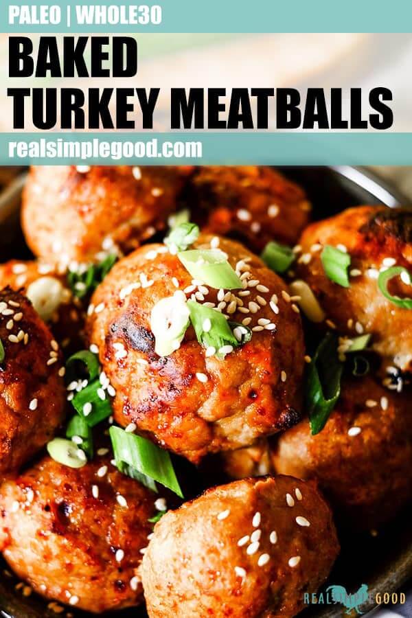 Close up shot of baked turkey meatballs with green onion and sesame seeds long pin. 