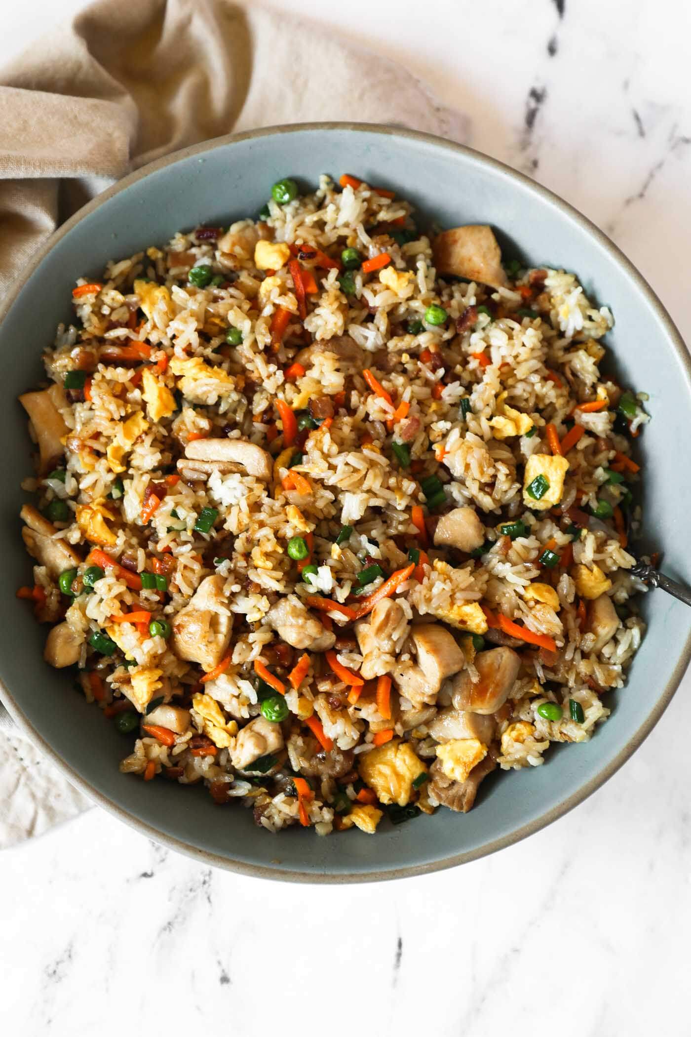 An overhead image of the fried rice in a large serving bowl with a spoon.