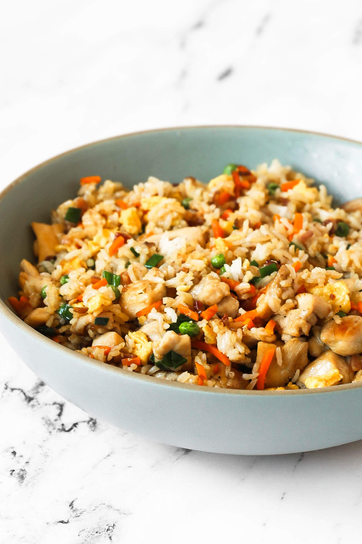 Angled image of a large serving bowl full of fried rice.