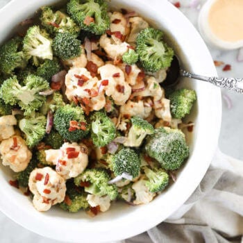 Overhead shot of creamy keto broccoli & cauliflower salad with bacon bits on top