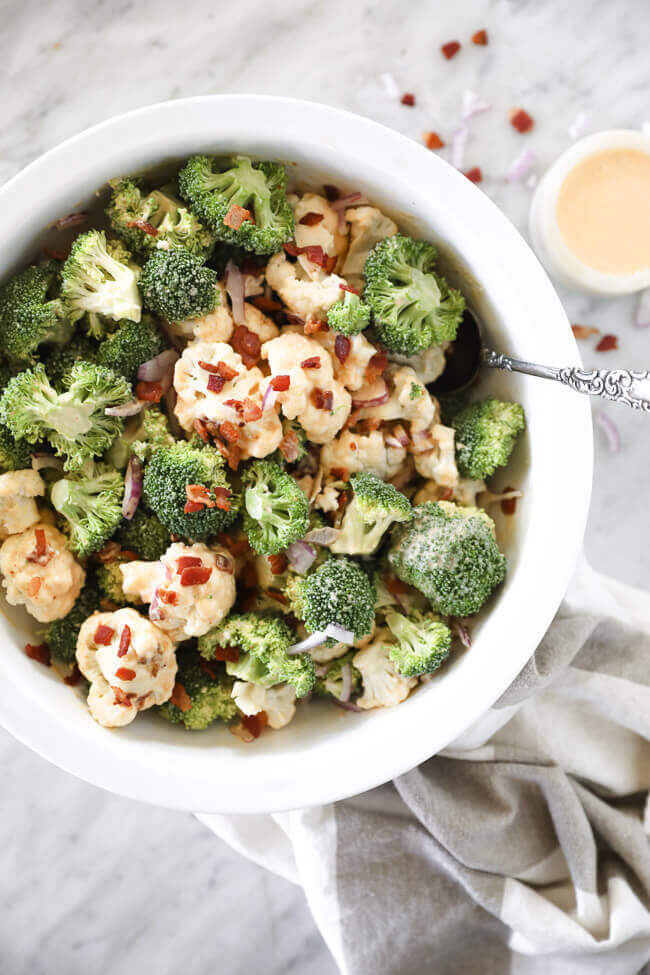 Overhead shot of creamy keto broccoli & cauliflower salad with bacon bits on top