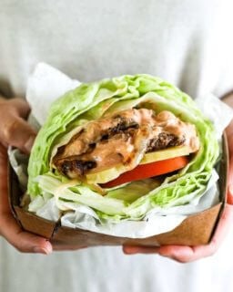 Bunless burger recipe vertical image hands holding burger