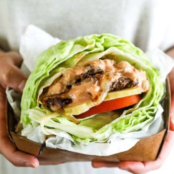 Bunless burger recipe vertical image hands holding burger