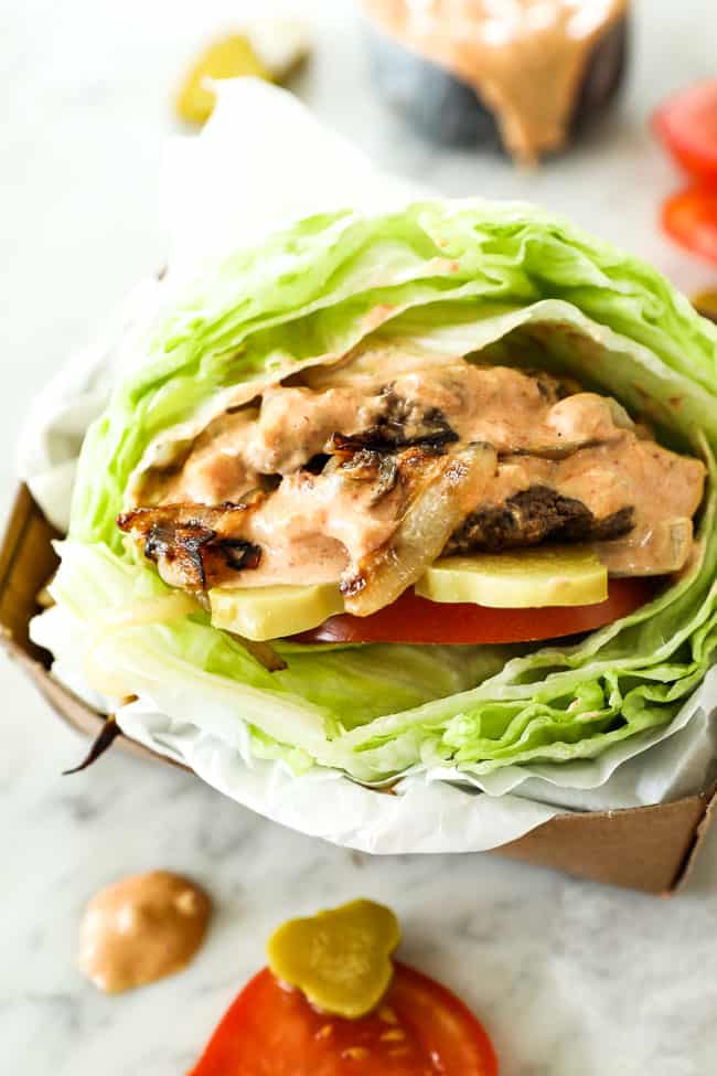 Bunless burger recipe vertical image close up of burger in basket.