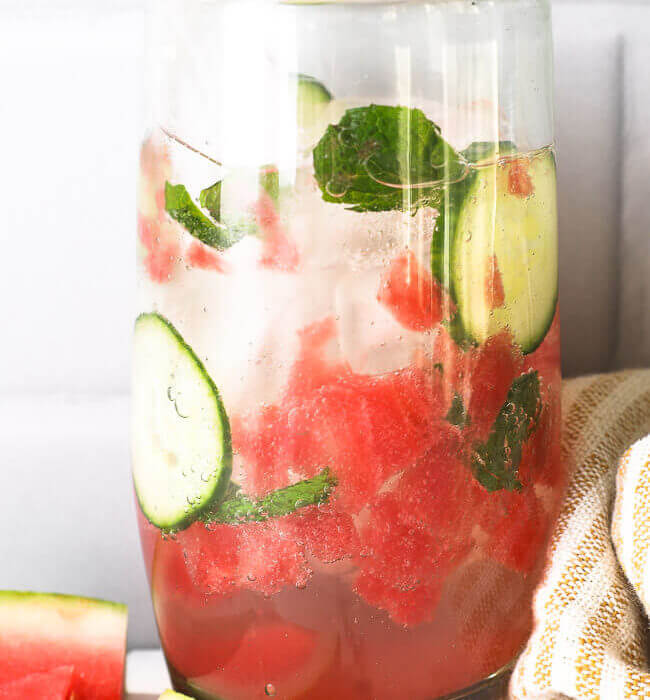 Tall glass filled with watermelon cucumber mojito mocktail