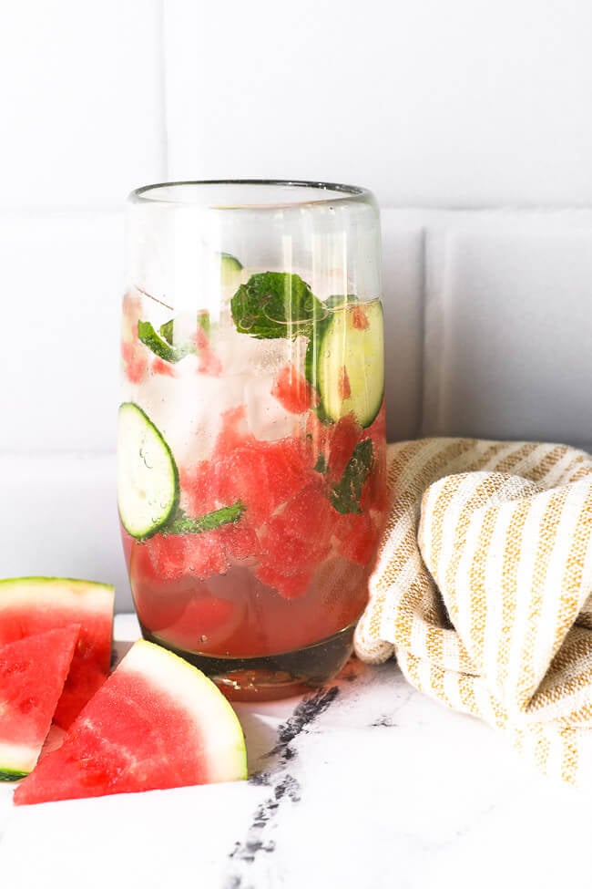 One tall glass filled with watermelon, cucumber, mint, ice, sparkling water and a little sweetener. A great summer mocktail. 