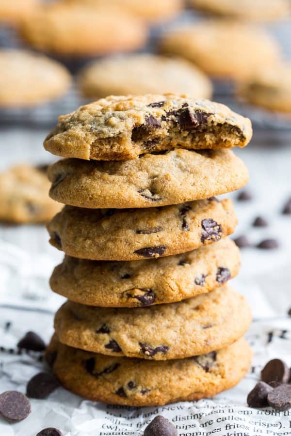 Stack of chocolate chip cookies, top cookie with bit out
