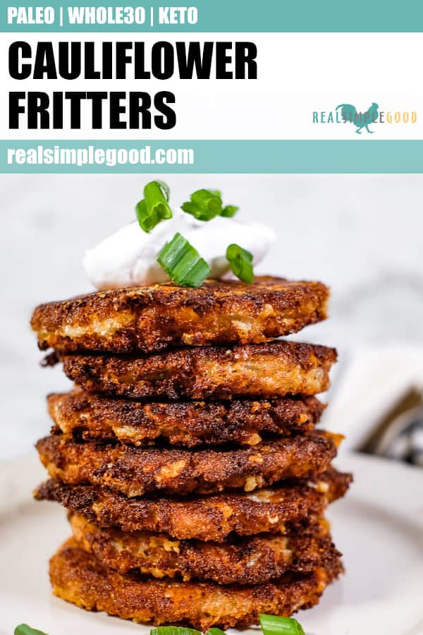 Stack of cauliflower fritters, topped with coconut yogurt and chopped green onion. 