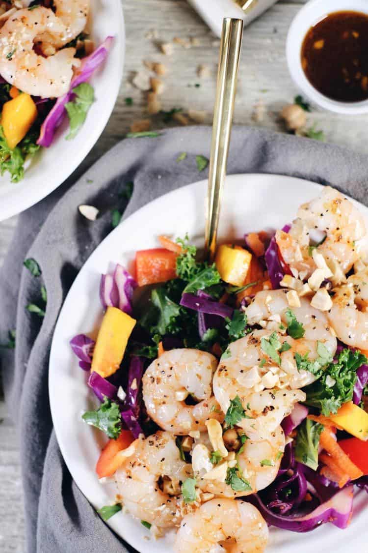 This chopped Thai shrimp salad is like eating the rainbow! It's packed with fruit, veggies and fresh herbs! Make this nutritious salad filled with kale, cabbage, bell pepper, carrots, mango and cilantro. It’s super easy and quick to make! Paleo, Whole30 + Gluten-Free, Dairy-Free. | realsimplegood.com