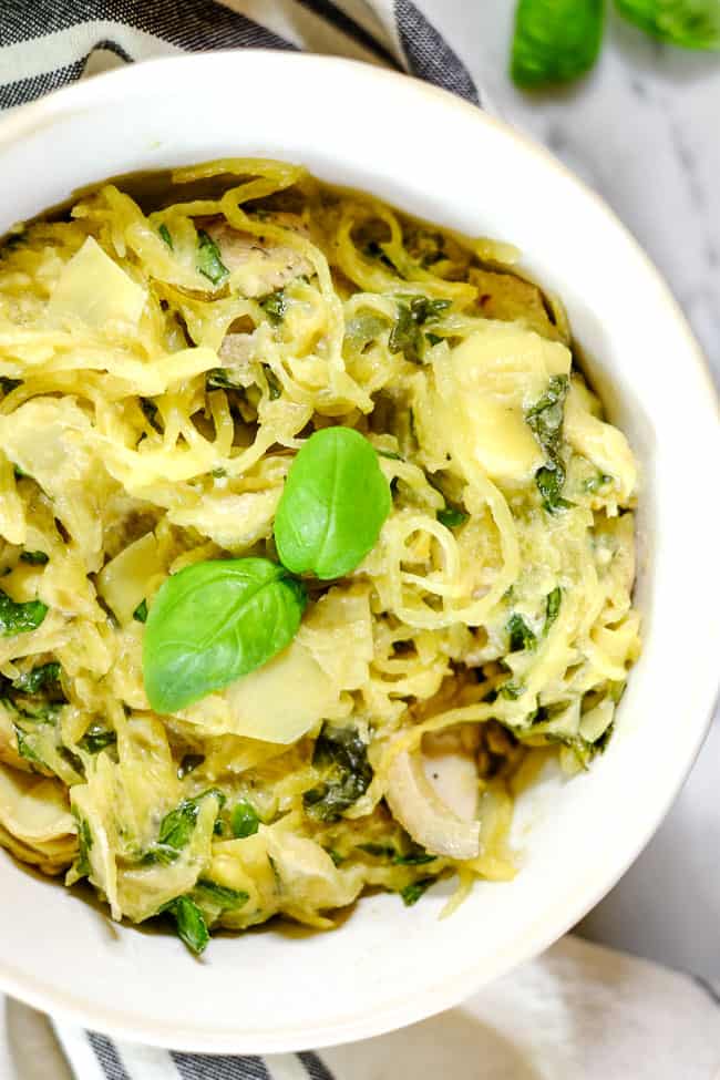Creamy chicken casserole served in a bowl with fresh basil on top. 