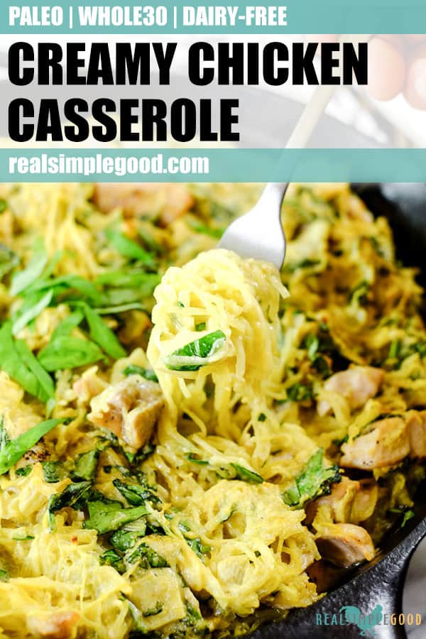 Creamy chicken casserole in cast iron skillet with fork scooping a bite out. 